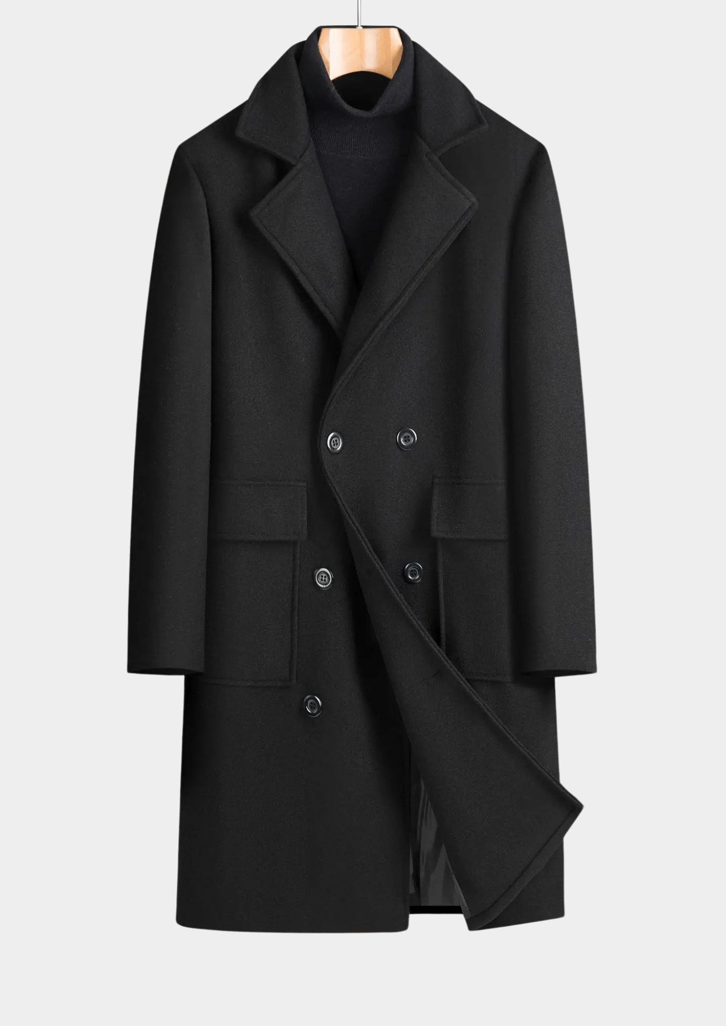 Black coat on a hanger against a light gray background