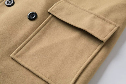 Close-up of a beige coat with a pocket and button details on a white background