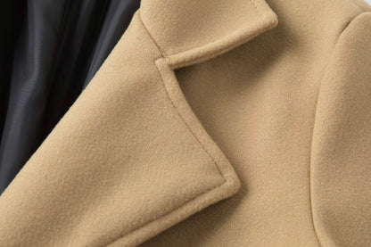 Close-up of a beige coat with a black background