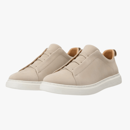 Beige sneakers on a white background
