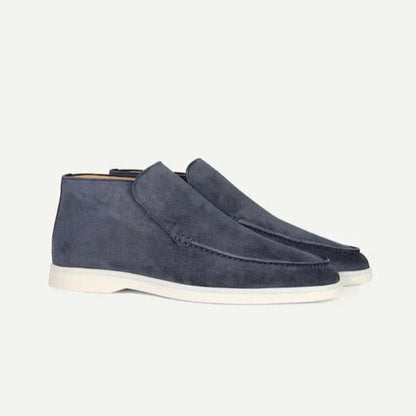 Pair of blue suede shoes on a light gray background