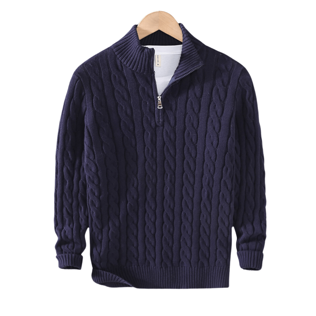 Navy blue cable knit sweater on a wooden hanger with a white background