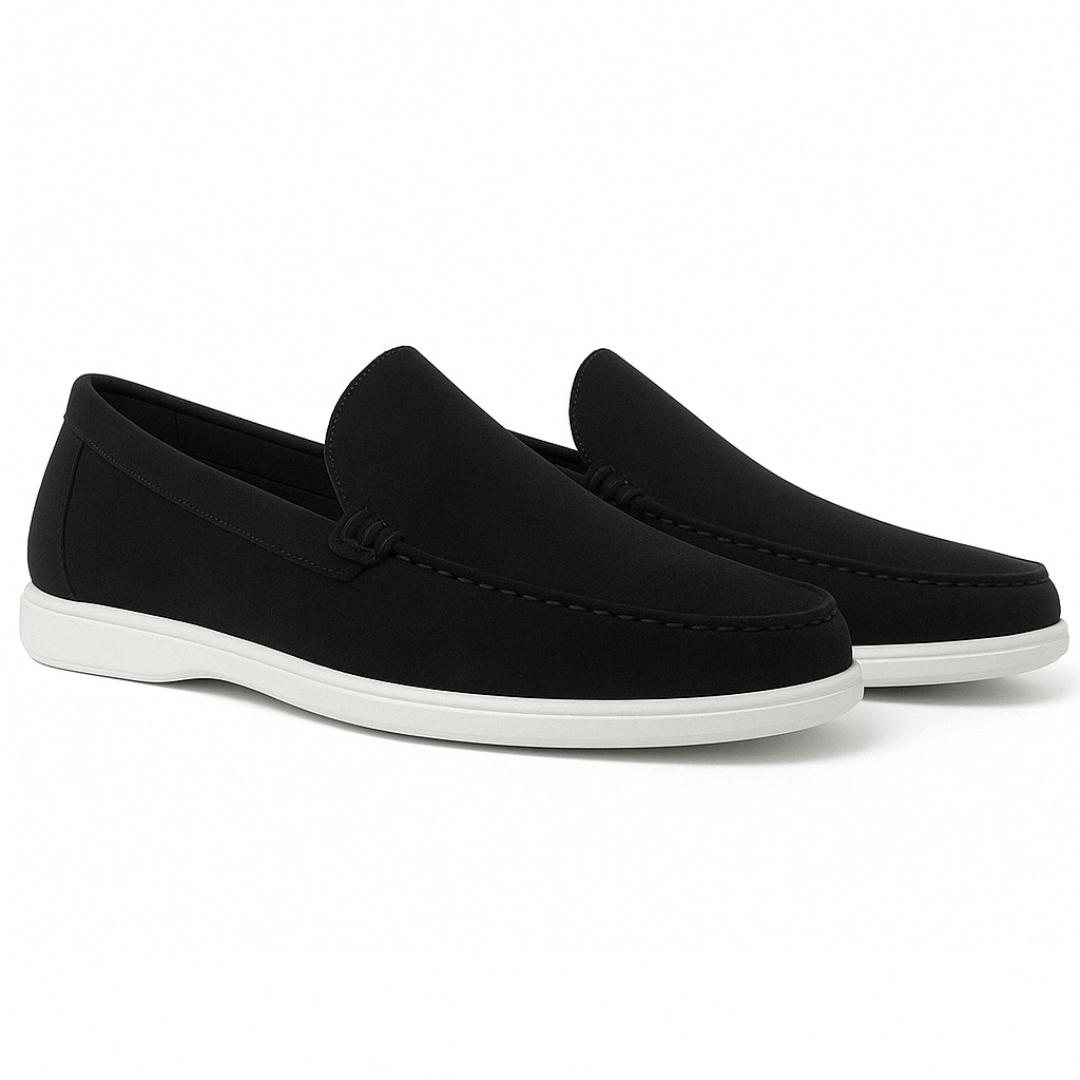 Black loafers with white soles on a white background