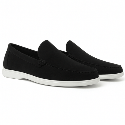 Black loafers with white soles on a white background