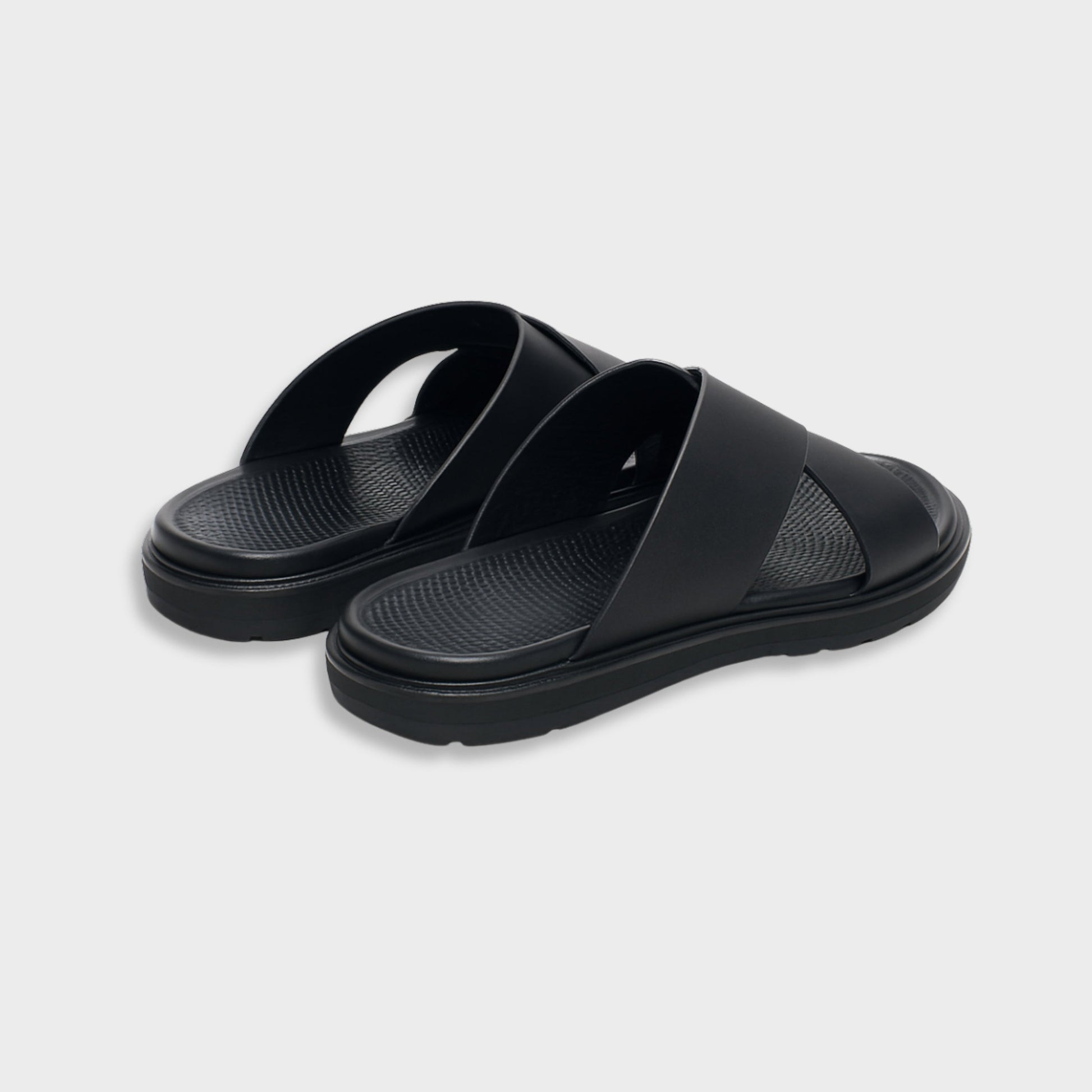 Classic black luxury EVA cross sandal for men, showing the modern silhouette and flexible flat sole.