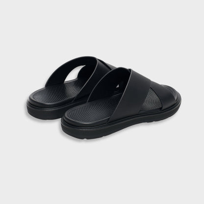 Classic black luxury EVA cross sandal for men, showing the modern silhouette and flexible flat sole.