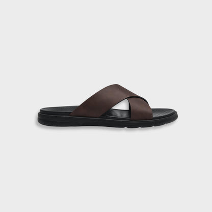 Men's brown NAXOS cross-strap sandal featuring a sleek minimalist design and contoured EVA footbed.