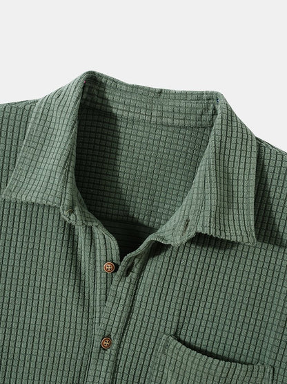 Green textured shirt with collar and buttons on a light gray background