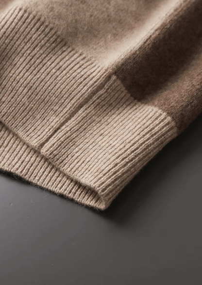 Close-up of a brown knitted sweater on a dark surface