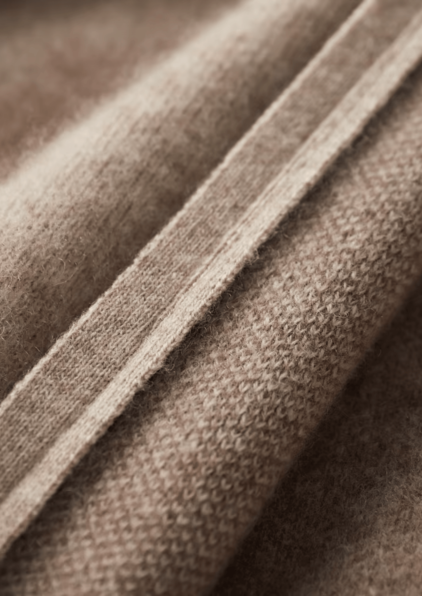 Close-up of brown fabric with a visible seam
