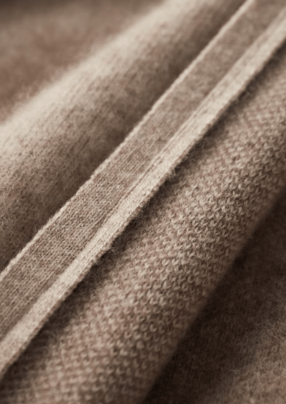 Close-up of brown fabric with a visible seam