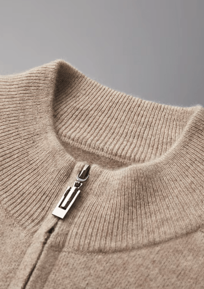 Close-up of a beige sweater with a zipper on a gray background