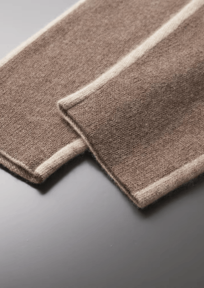 Two brown rectangular mats with white edges on a gray surface