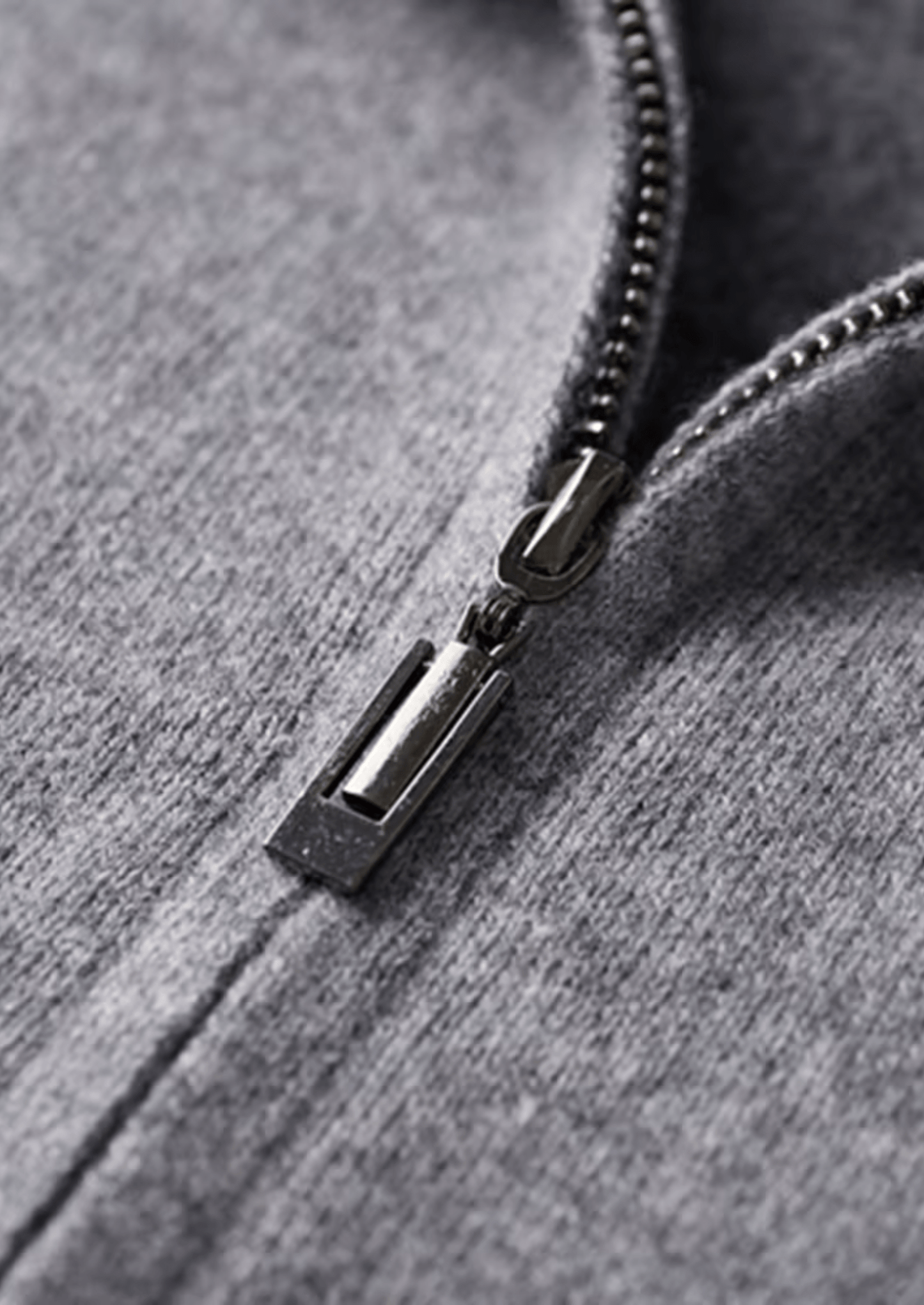 Close-up of a zipper on a gray hoodie