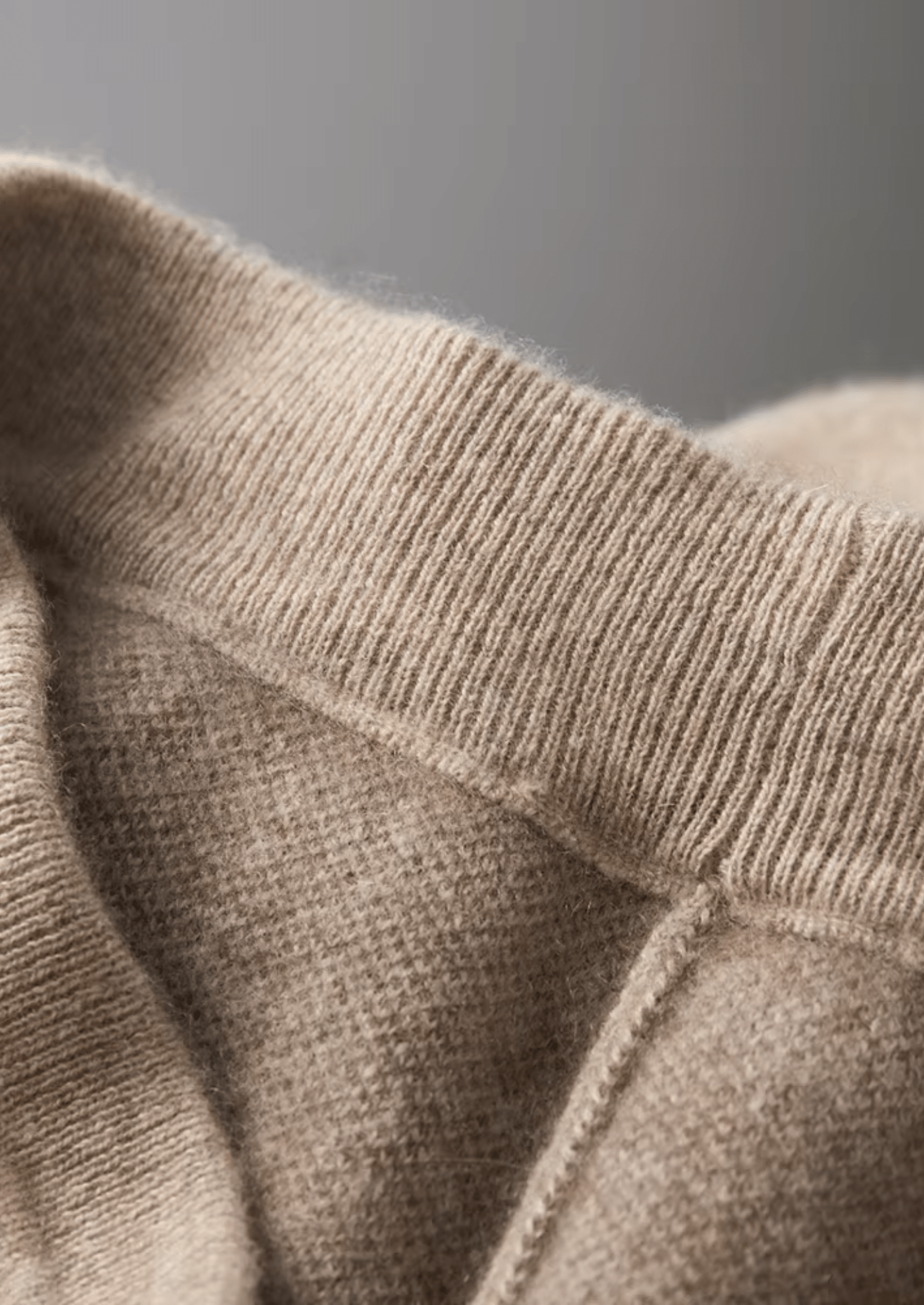 Close-up of beige knitted fabric with a blurred background