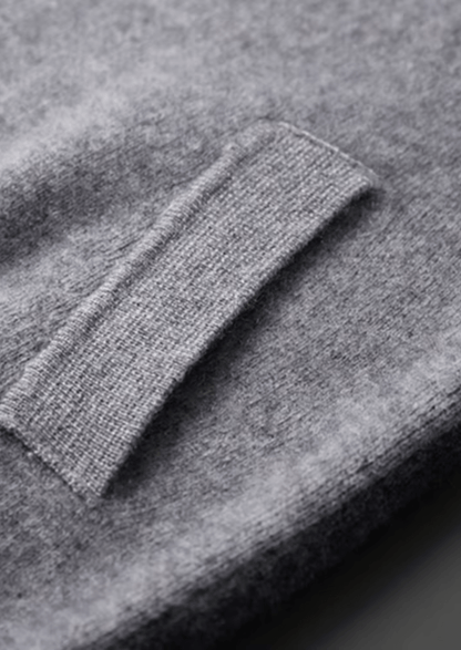 Close-up of a gray sweater with a focus on the sleeve.