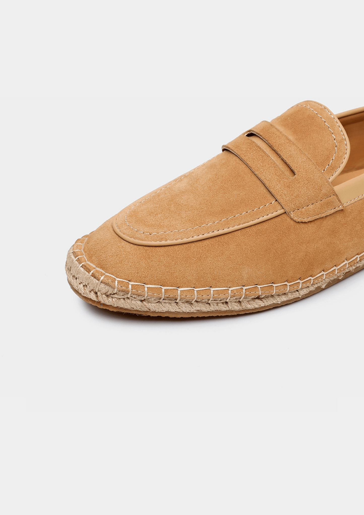 Tan espadrille shoe on a light gray background