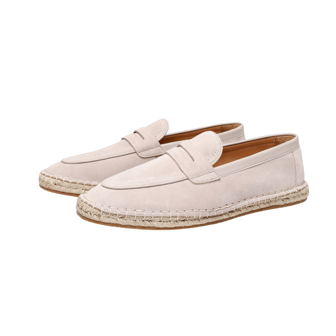 Pair of cream-colored espadrille loafers on a white background