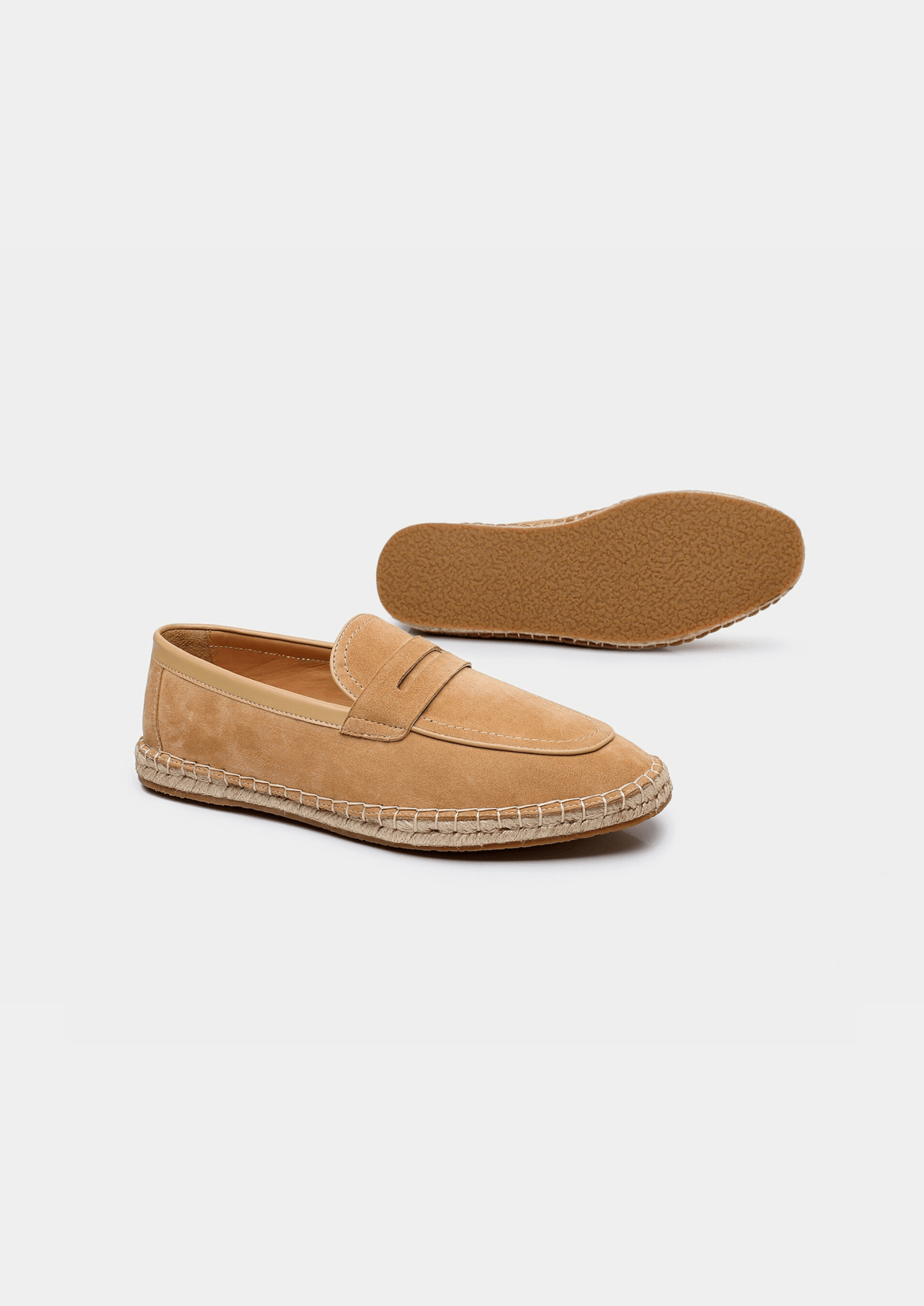 Tan espadrille loafers on a white background