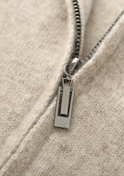 Close-up of a zipper on a beige fabric background