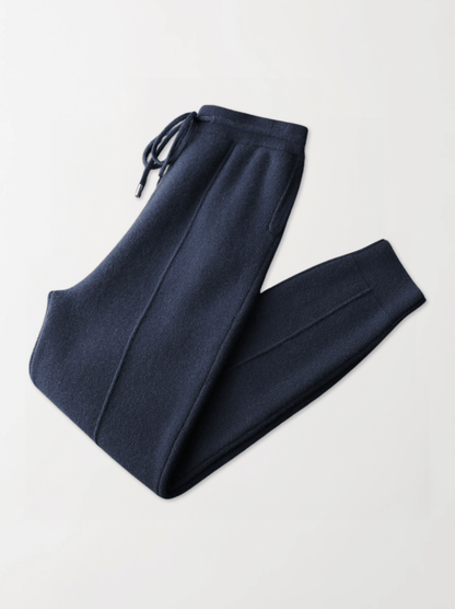 Pair of navy blue sweatpants on a light gray background