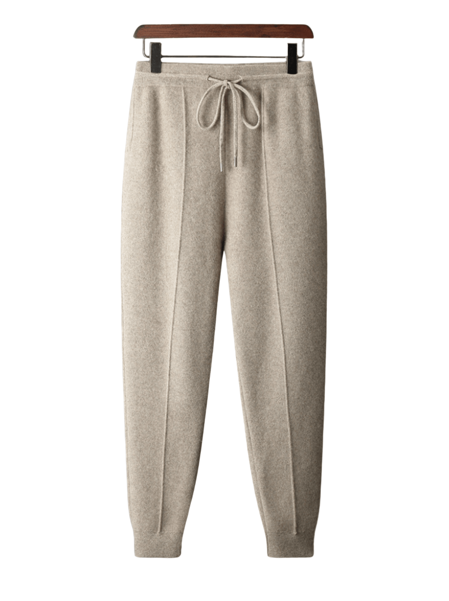 Beige sweatpants on a hanger against a white background