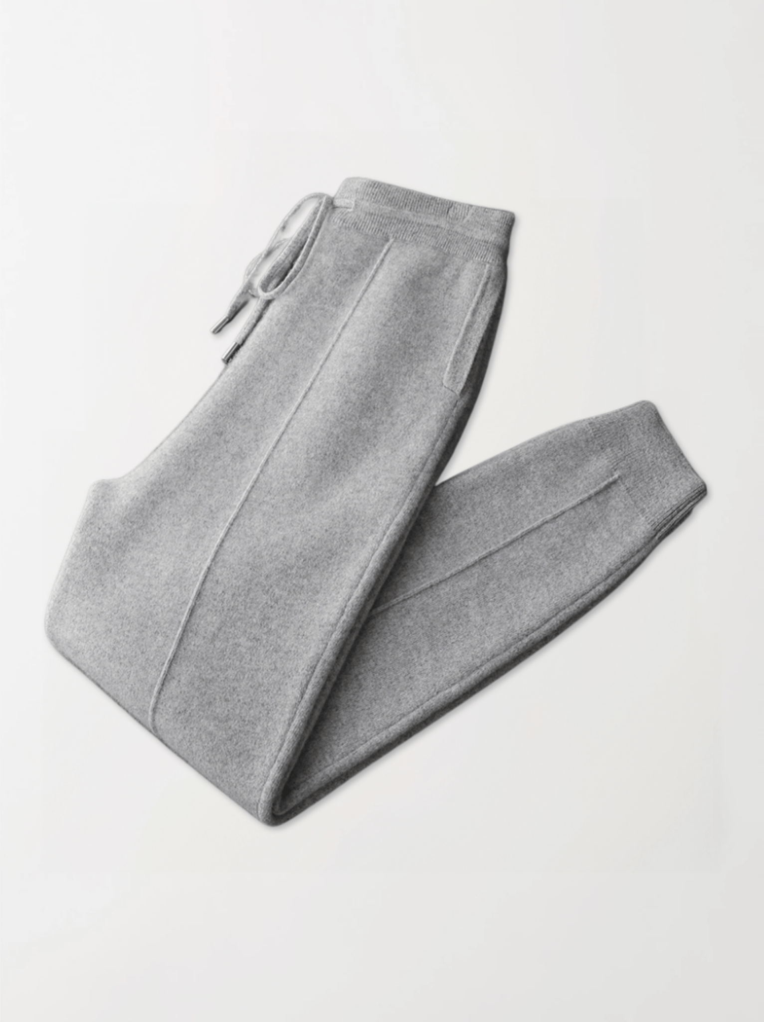 Gray sweatpants folded on a light gray background