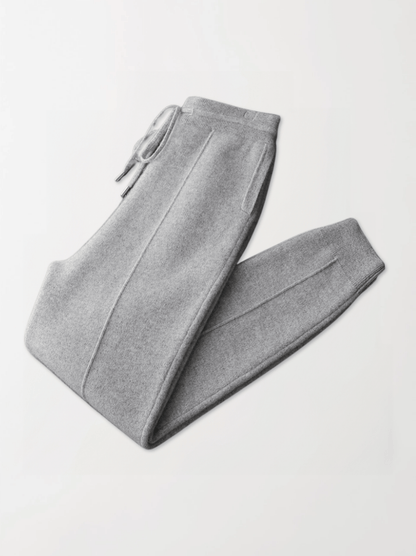 Gray sweatpants folded on a light gray background