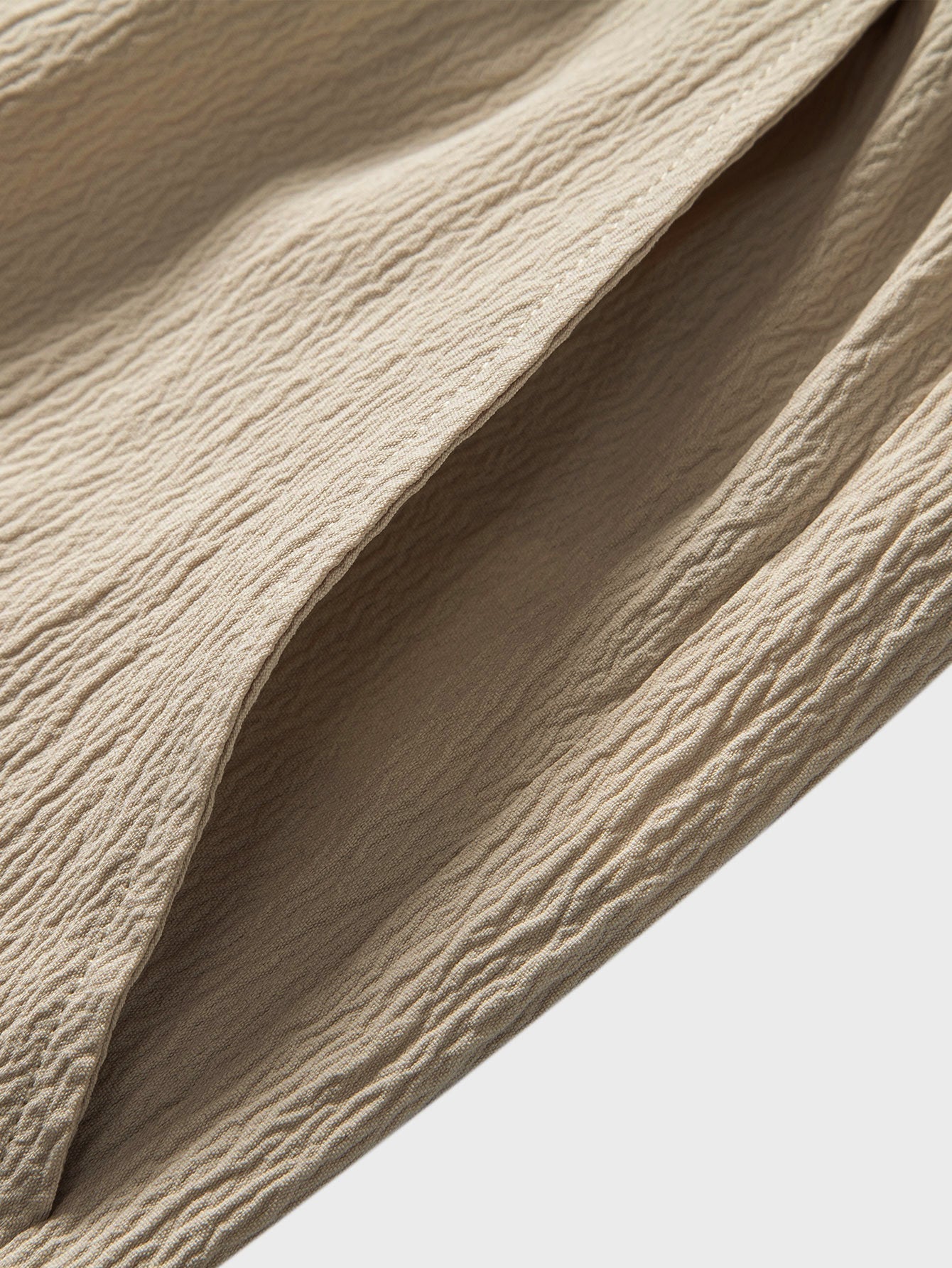 Close-up of beige fabric with texture on a light background