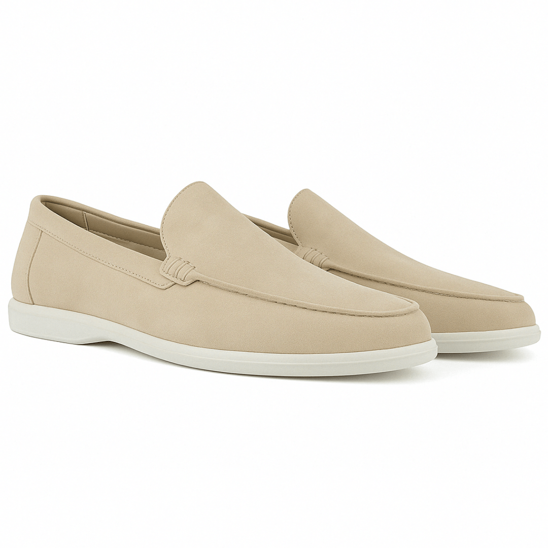 Pair of beige loafers on a white background