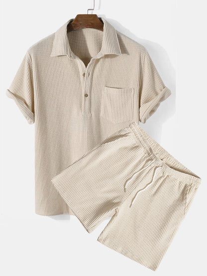 Beige ribbed knit shirt and shorts set on a white background