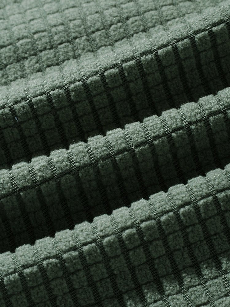 Close-up of green textured fabric with a grid pattern