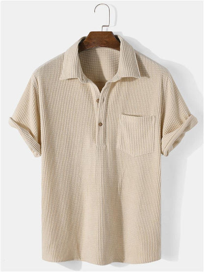 Beige short-sleeve shirt on a hanger against a white background