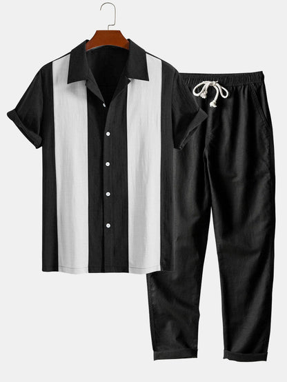 Black and white shirt with matching pants on a hanger against a white background