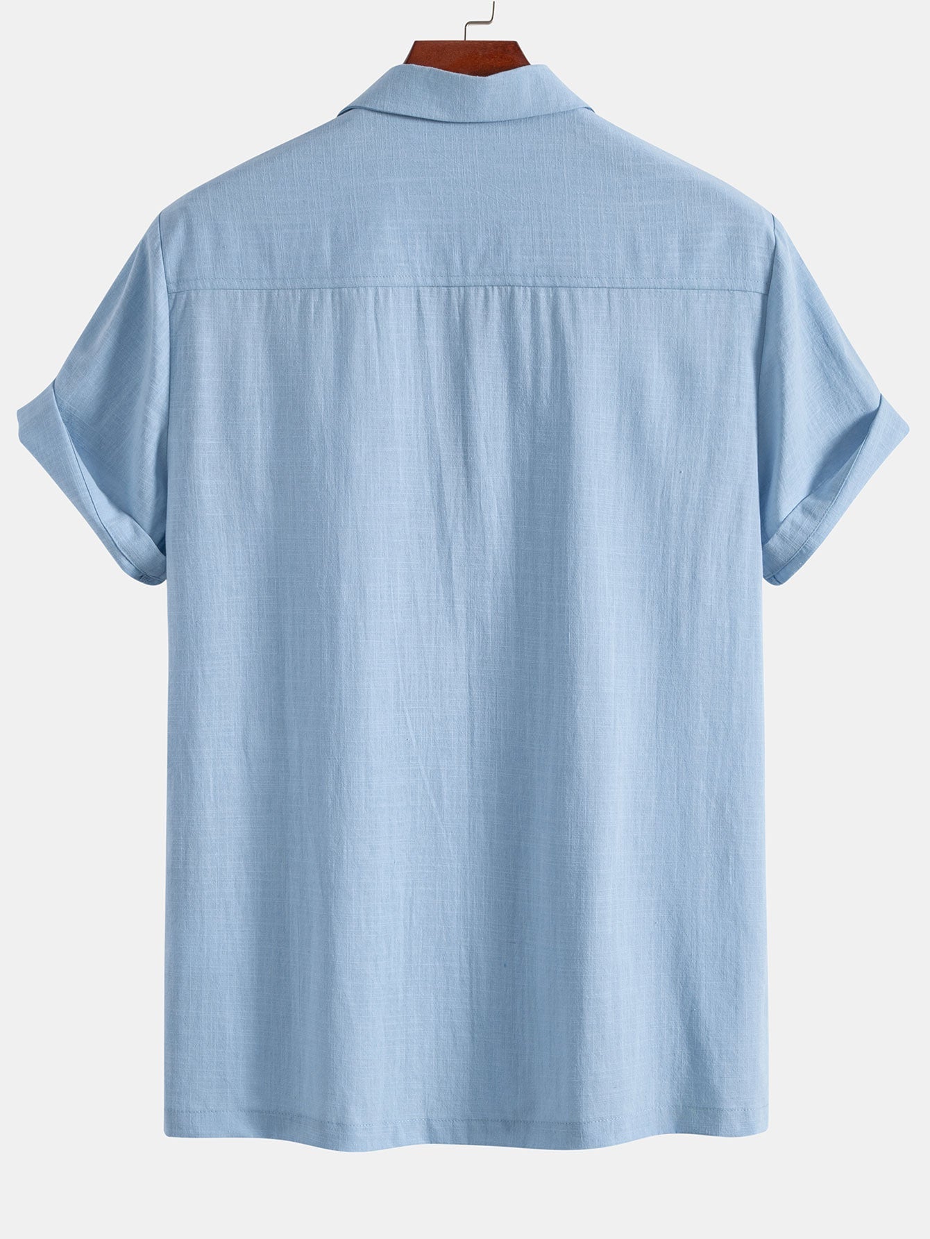 Light blue short-sleeve shirt on a hanger against a white background