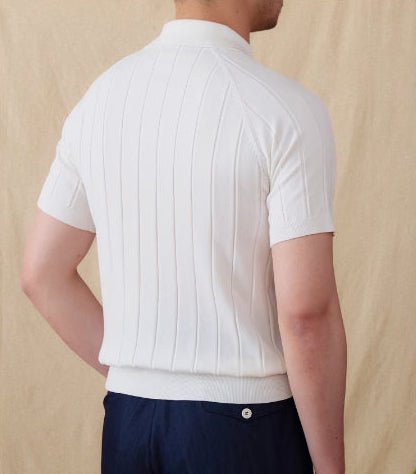 Minimalist white ribbed knit polo showcasing the vertical stripe texture and refined button-down collar.