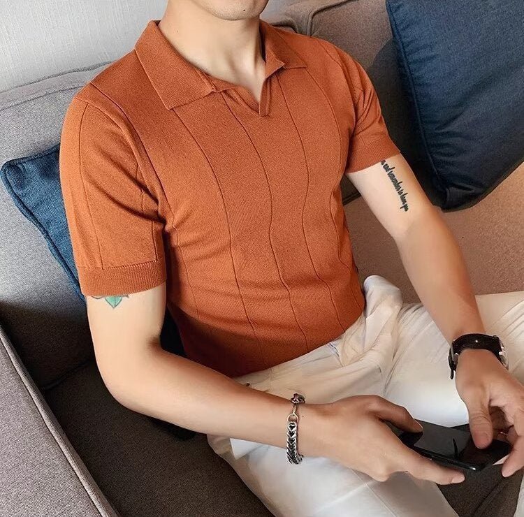 Men's burnt orange knitted polo featuring a sophisticated vertical ribbed texture and a clean, buttonless V-neckline.